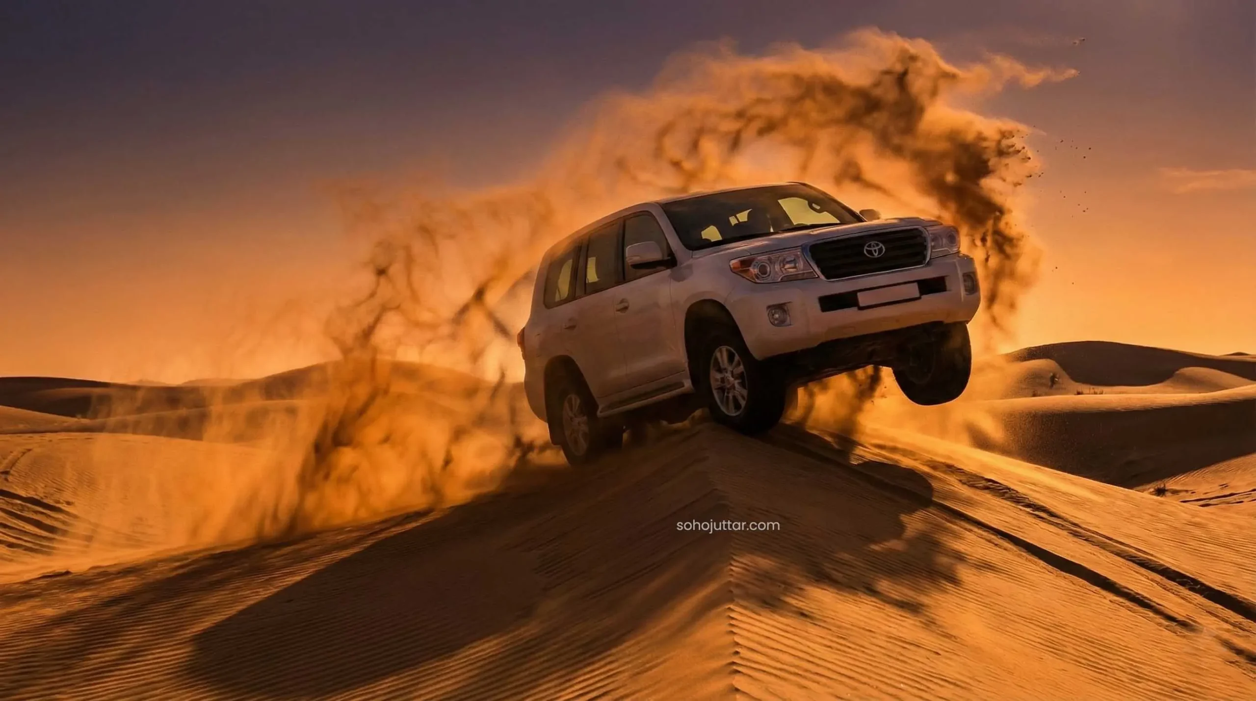 4x4 Land Cruiser dune bashing at sunset in Dubai desert safari
